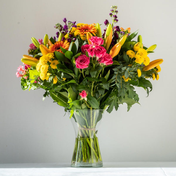 Emily Vase - A colourful, vibrant and bold bouquet with Gerbera’s, Santini and Hypericum Berries. Displayed in a vase, same day delivery in Bournemouth.