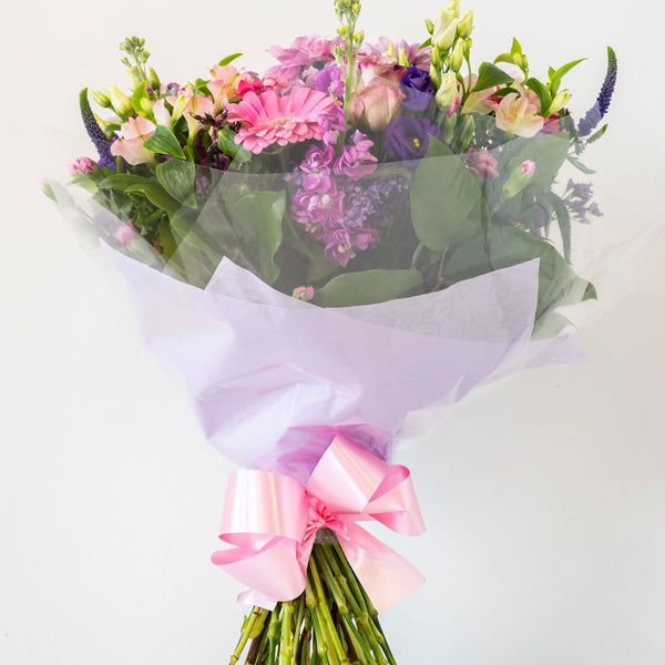 Hayley Hand-Tied - Soft, pretty and delicate lilac floral arrangement of Lisianthus, long lasting Carnations, Alstromeria and Liminioum. Seasonal hand-tied bouquet for same day delivery in Bournemouth.