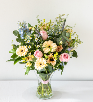 Sophie Vase - elegant, calm and relaxing pastel bouquet with Freesia, handpicked Delphinium and soft foliage. Displayed in a vase for same day delivery in Bournemouth.