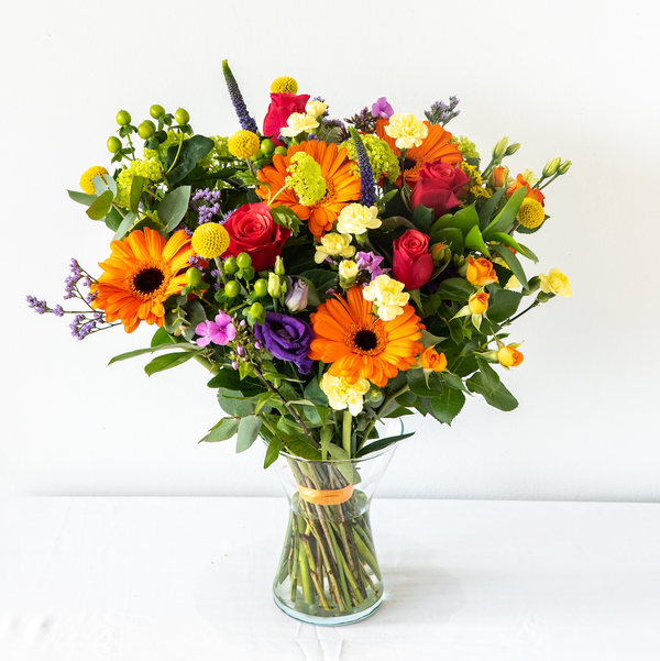 Emily Vase - A colourful, vibrant and bold bouquet with Gerbera’s, Santini and Hypericum Berries. Displayed in a vase, same day delivery in Bournemouth.