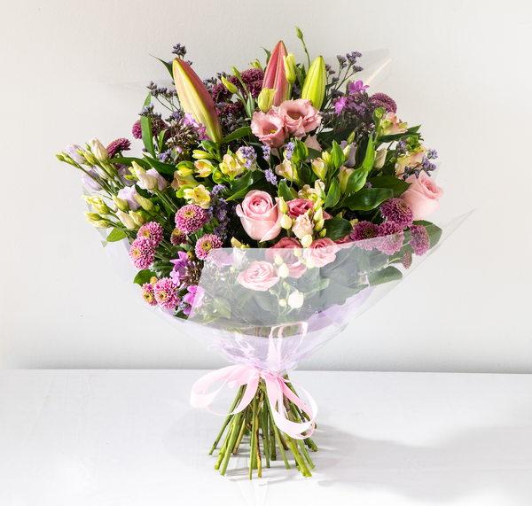 Hayley Hand-Tied - Soft, pretty and delicate lilac floral arrangement of Lisianthus, long lasting Carnations, Alstromeria and Liminioum. Seasonal hand-tied bouquet for same day delivery in Bournemouth.