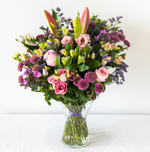 Hayley Vase - Soft, pretty and delicate lilac floral arrangement of Lisianthus, long lasting Carnations, Alstromeria and Liminioum. Seasonal bouquet displayed in a vase for same day delivery in Bournemouth.