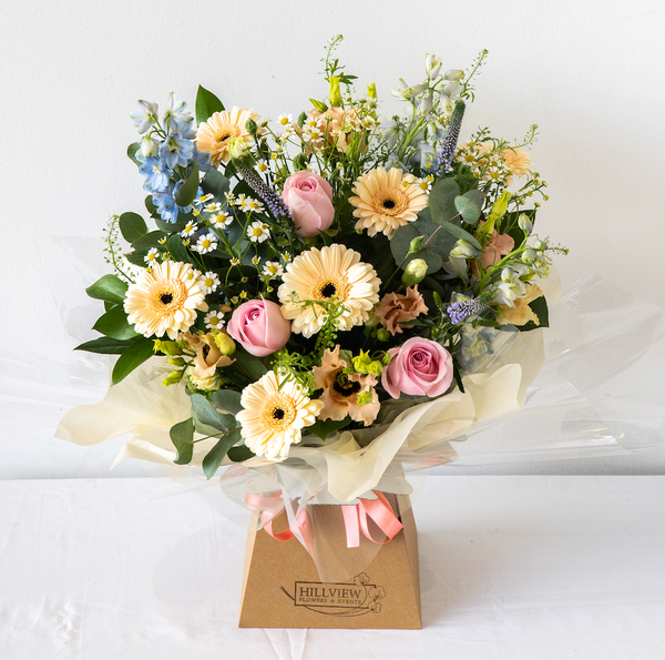 Sophie Aqua Pack - elegant, calm and relaxing pastel bouquet with Freesia, handpicked Delphinium and soft foliage. Displayed in an aqua pack for same day delivery in Bournemouth.