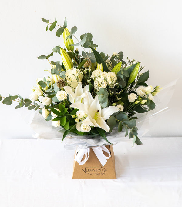 A classic, stylish and sophisticated natural white bouquet with greenery and eucalyptus for next day delivery in Bournemouth.